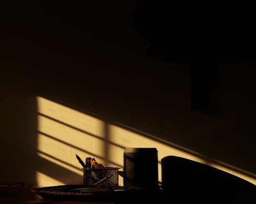 Soft morning sunlight entering through a window over a desk