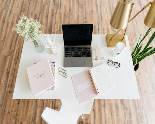 Organized desk with laptop and natural window light