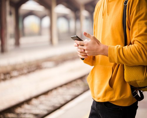 Commuter reading smartphone on a bus in Mexico